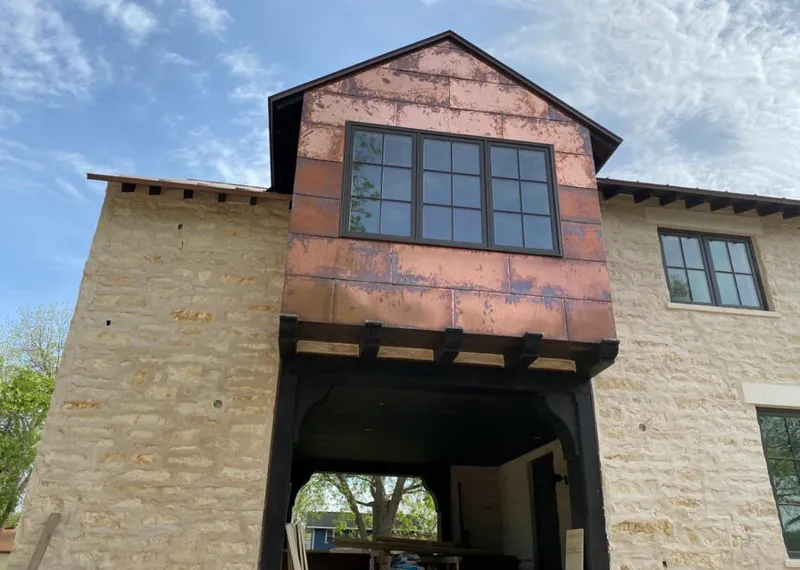 Copper metal panel facade on a stone building for Skylight Installation in Milford